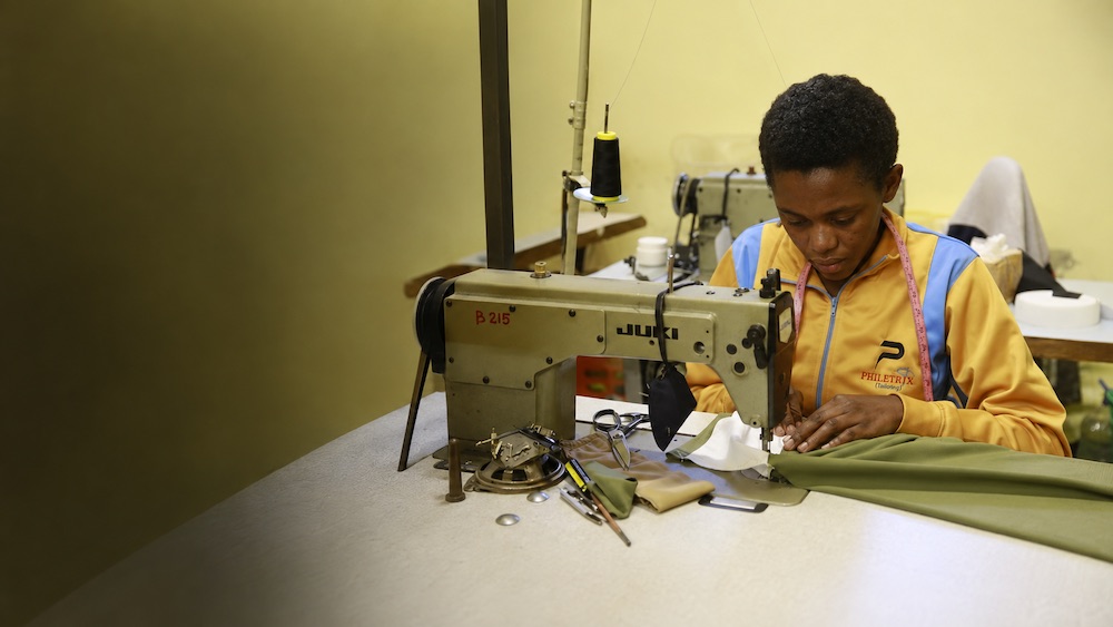 Philetrix tailor carefully sewing a custom garment